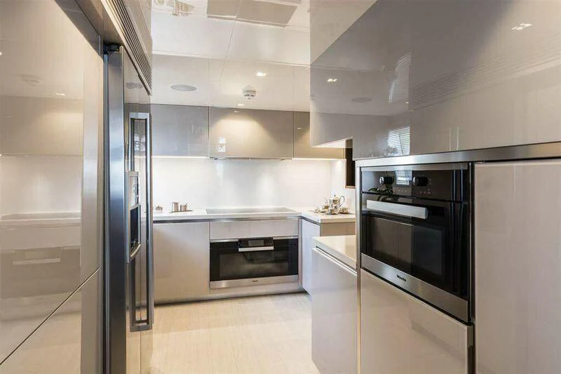 a kitchen with white cabinets aboard MIKIL Yacht for Sale