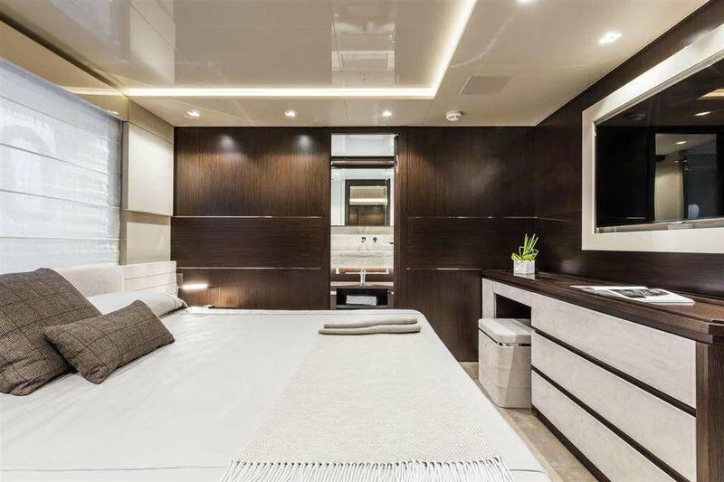 a large room with a bed and a desk aboard MIKIL Yacht for Sale