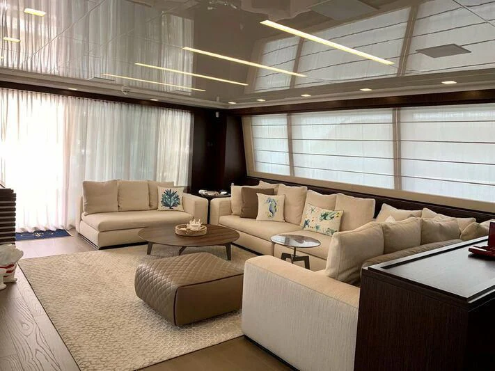 a living room with a couch and a coffee table aboard MIKIL Yacht for Sale