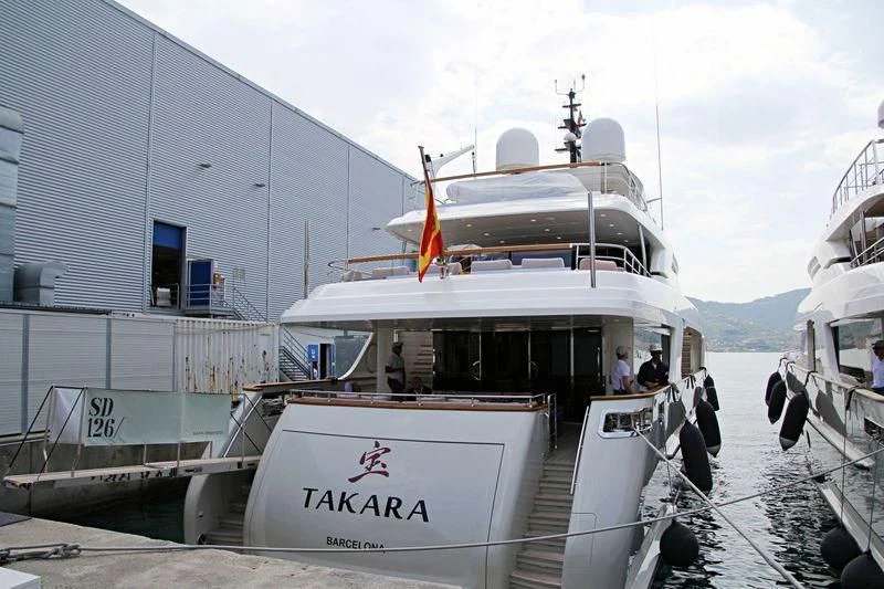 a boat docked at a pier aboard TAKARA ONE Yacht for Charter