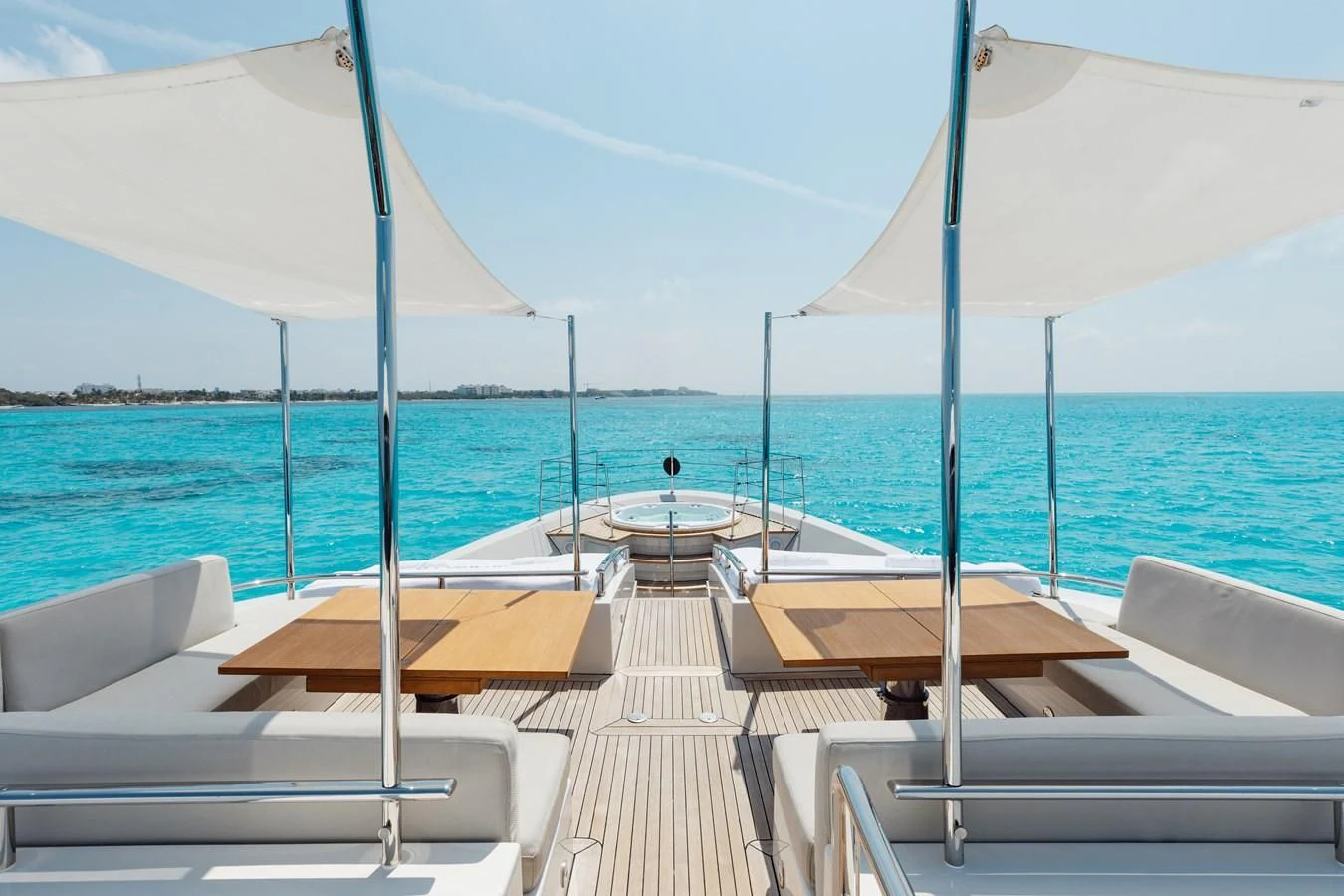 a group of lounge chairs on a boardwalk by the water aboard TAKARA ONE Yacht for Charter