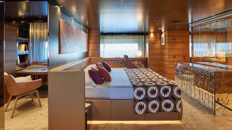 a room with a bed and a table aboard TAKARA ONE Yacht for Charter