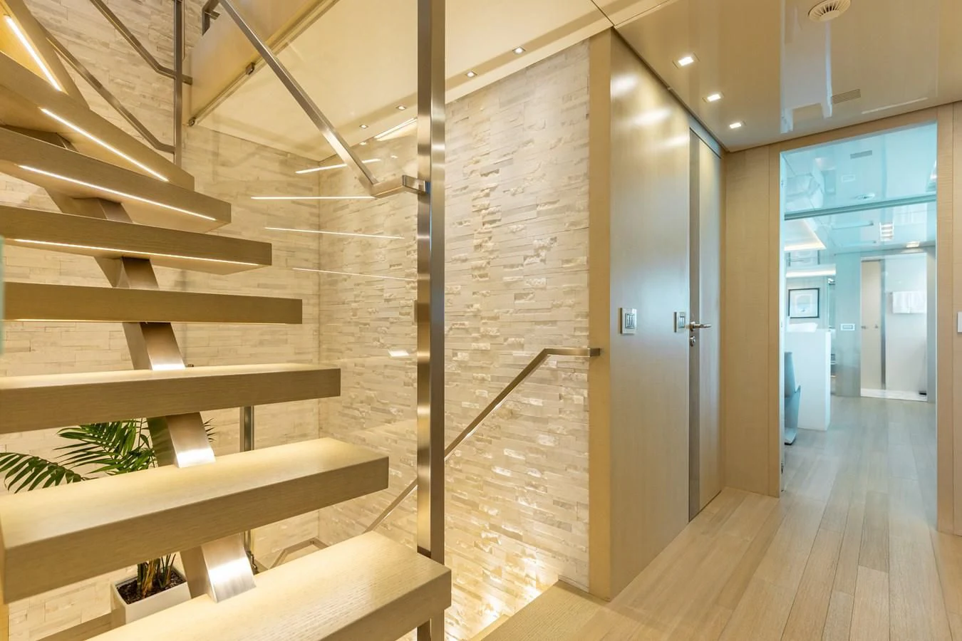 a room with a staircase and a glass door aboard TAKARA ONE Yacht for Charter