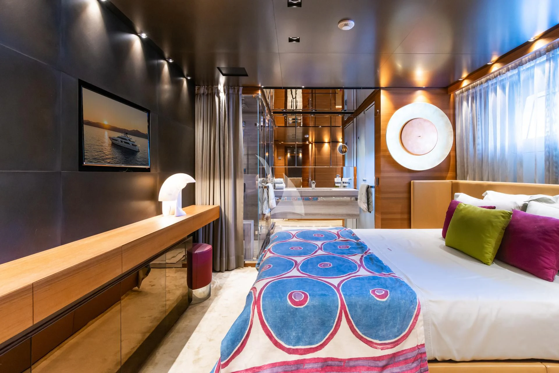 a room with a bed and a table aboard TAKARA ONE Yacht for Charter