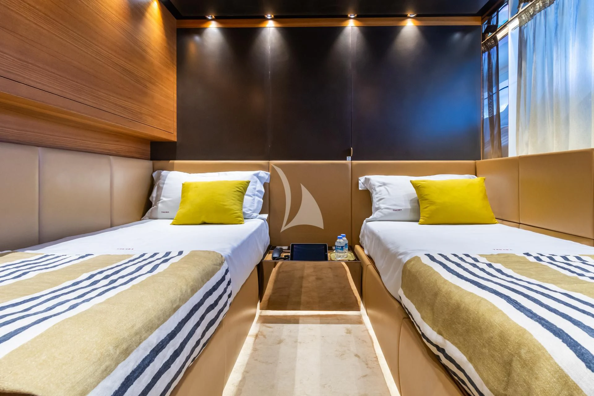 a room with beds and a wood wall aboard TAKARA ONE Yacht for Charter