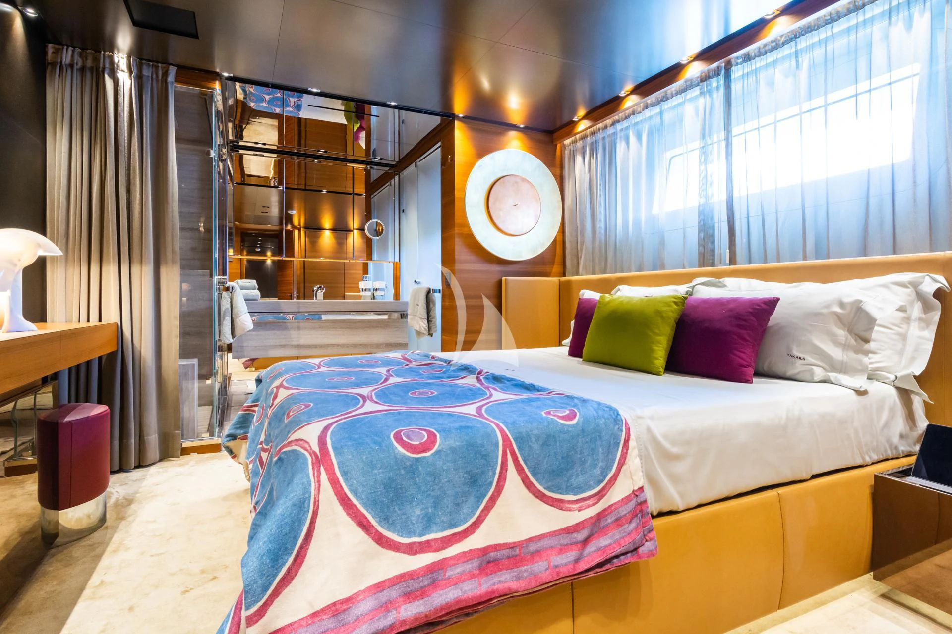 a bed with a red and white blanket aboard TAKARA ONE Yacht for Charter