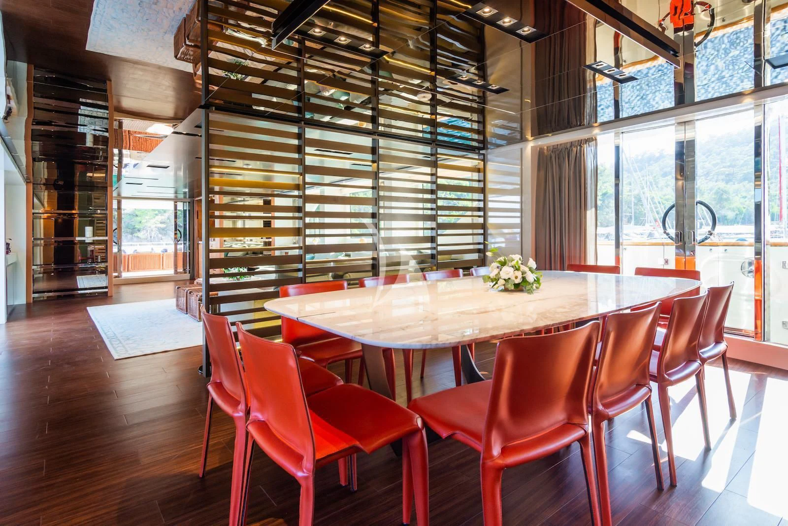 a table with red chairs aboard TAKARA ONE Yacht for Charter