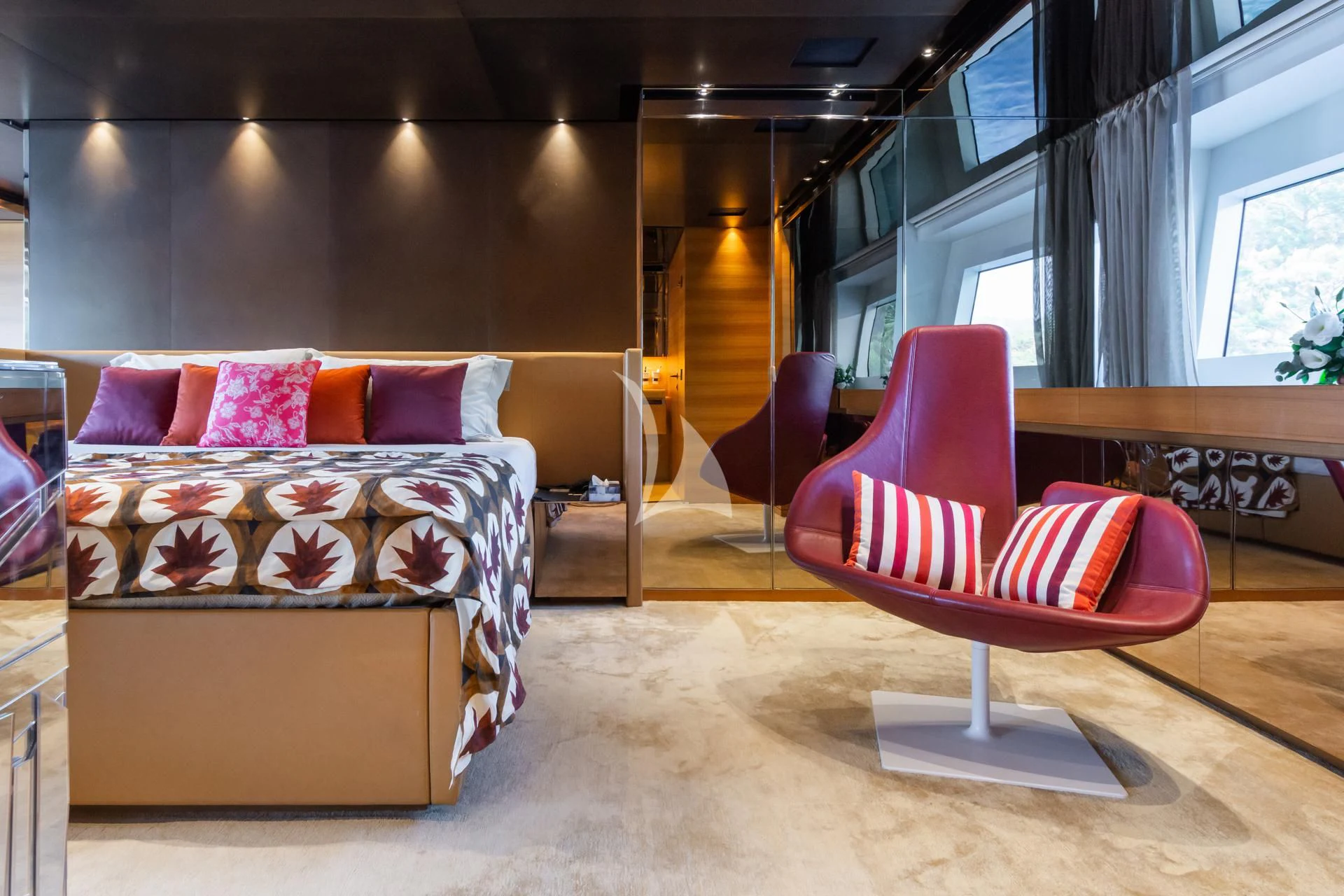 a room with a bed and a chair aboard TAKARA ONE Yacht for Charter