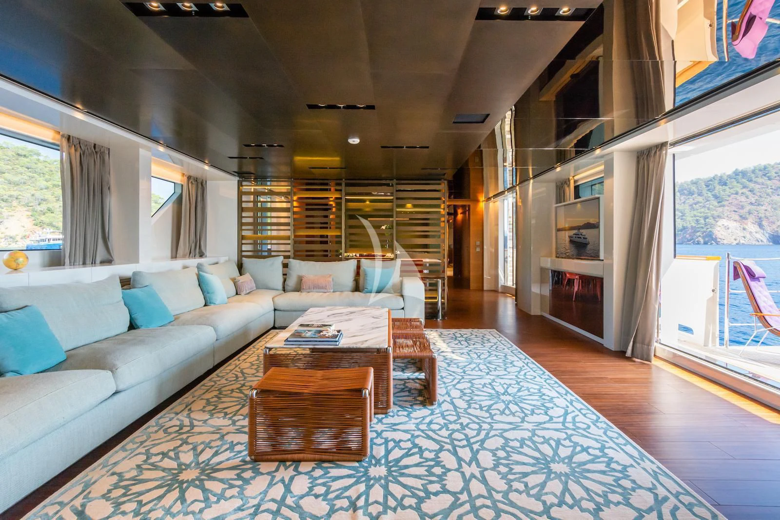 a living room with a large rug aboard TAKARA ONE Yacht for Charter