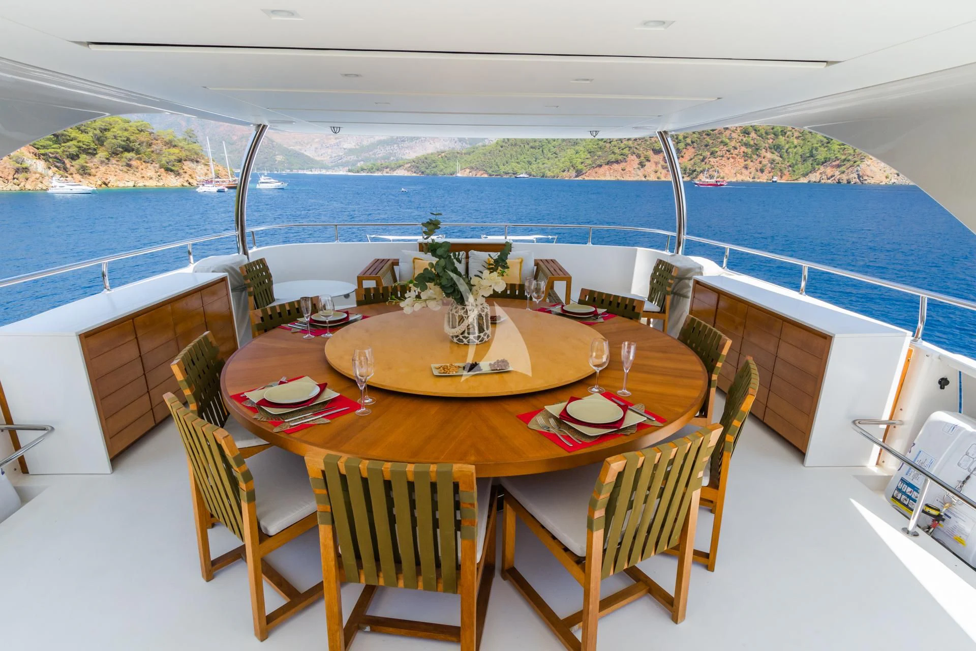 a table set for a meal on a balcony aboard TAKARA ONE Yacht for Charter