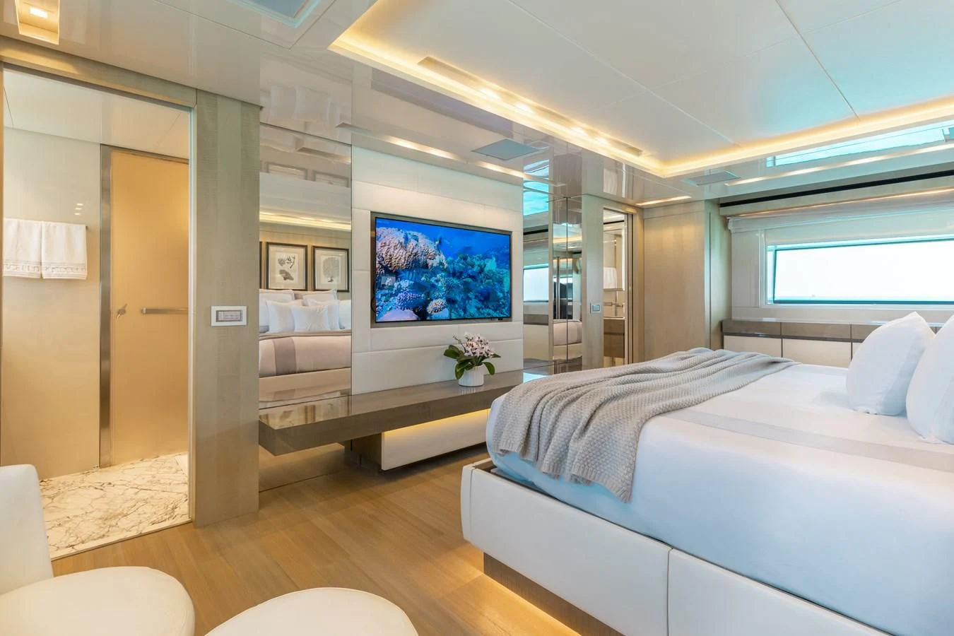 a room with a bed and a tv aboard TAKARA ONE Yacht for Charter