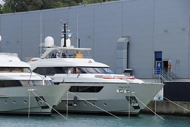 a white boat in a body of water aboard TAKARA ONE Yacht for Charter