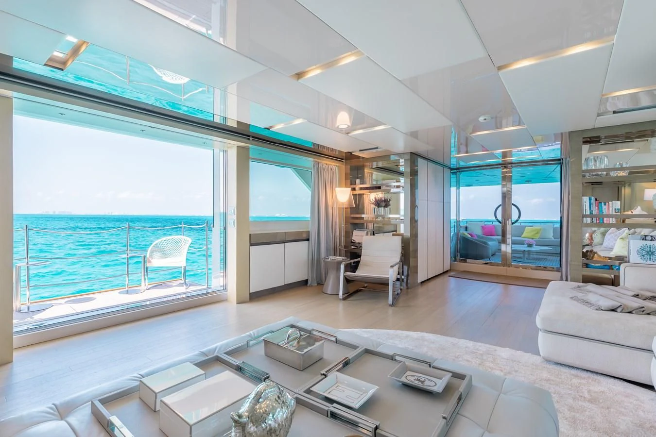 a modern looking living room with a large glass window aboard TAKARA ONE Yacht for Charter