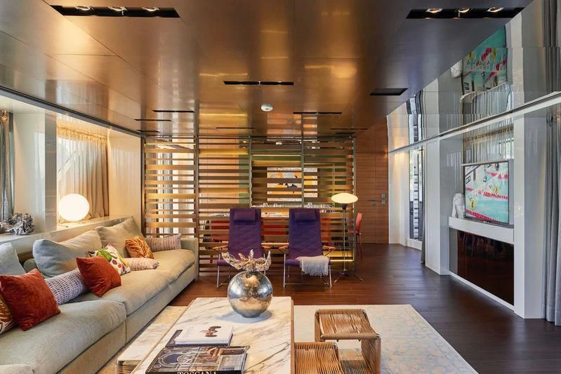 a living room with a large glass wall aboard TAKARA ONE Yacht for Charter