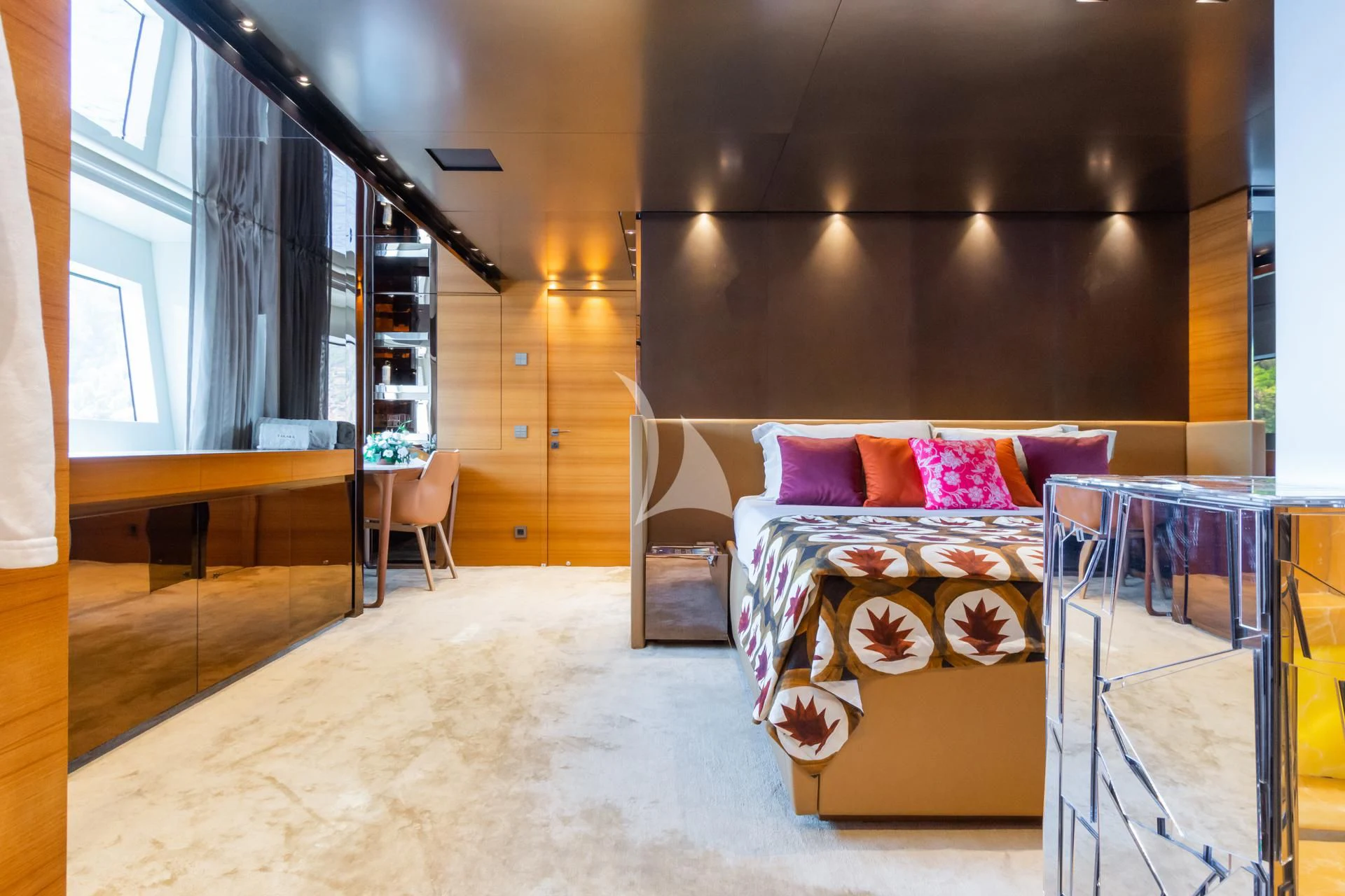 a room with a bed and a table aboard TAKARA ONE Yacht for Charter
