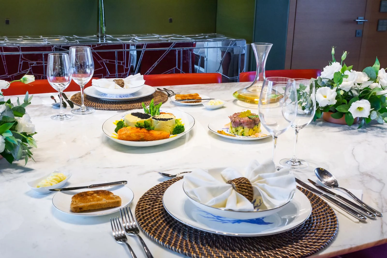 a table with plates of food and glasses on it aboard TAKARA ONE Yacht for Charter