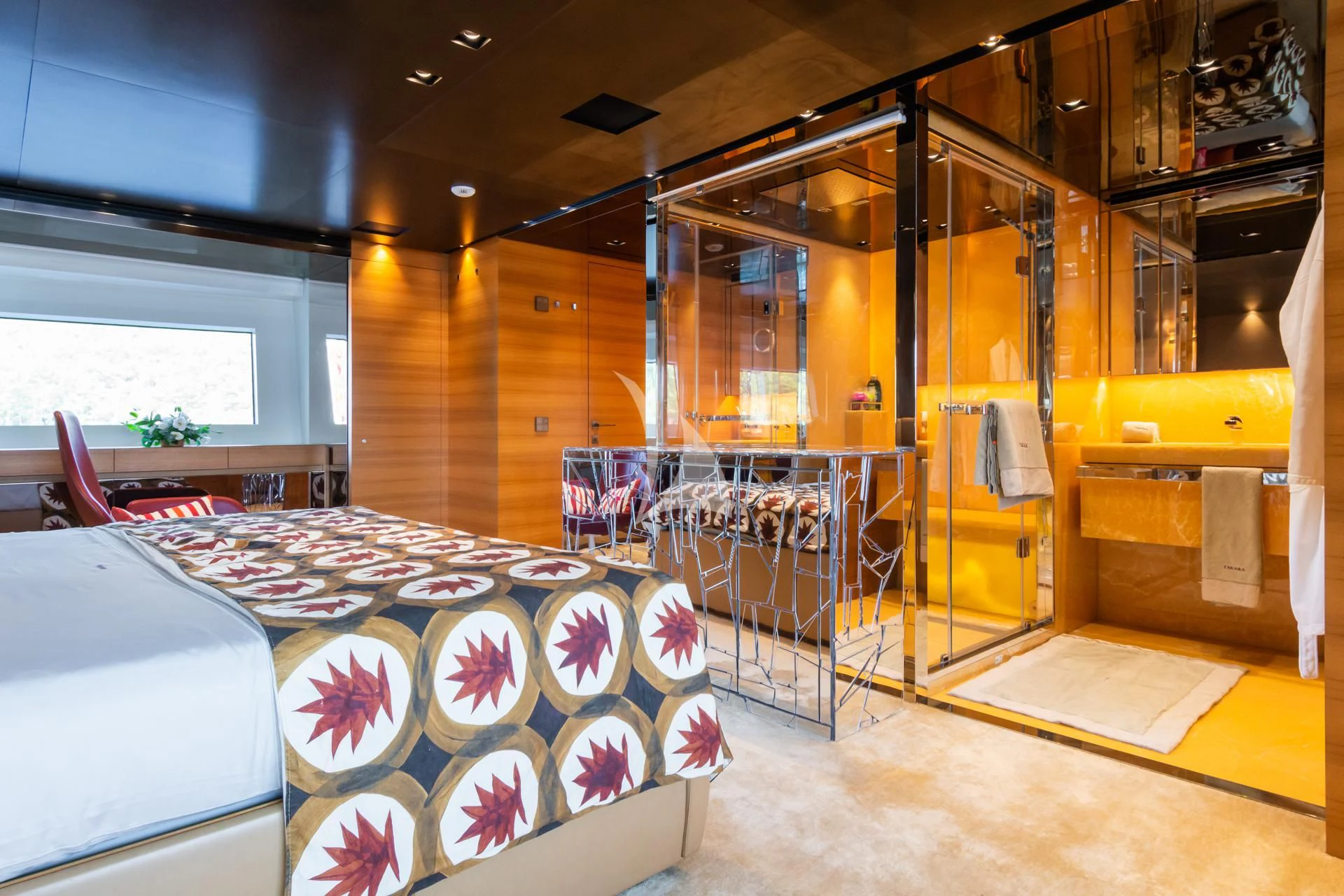 a room with a bed and a table aboard TAKARA ONE Yacht for Charter
