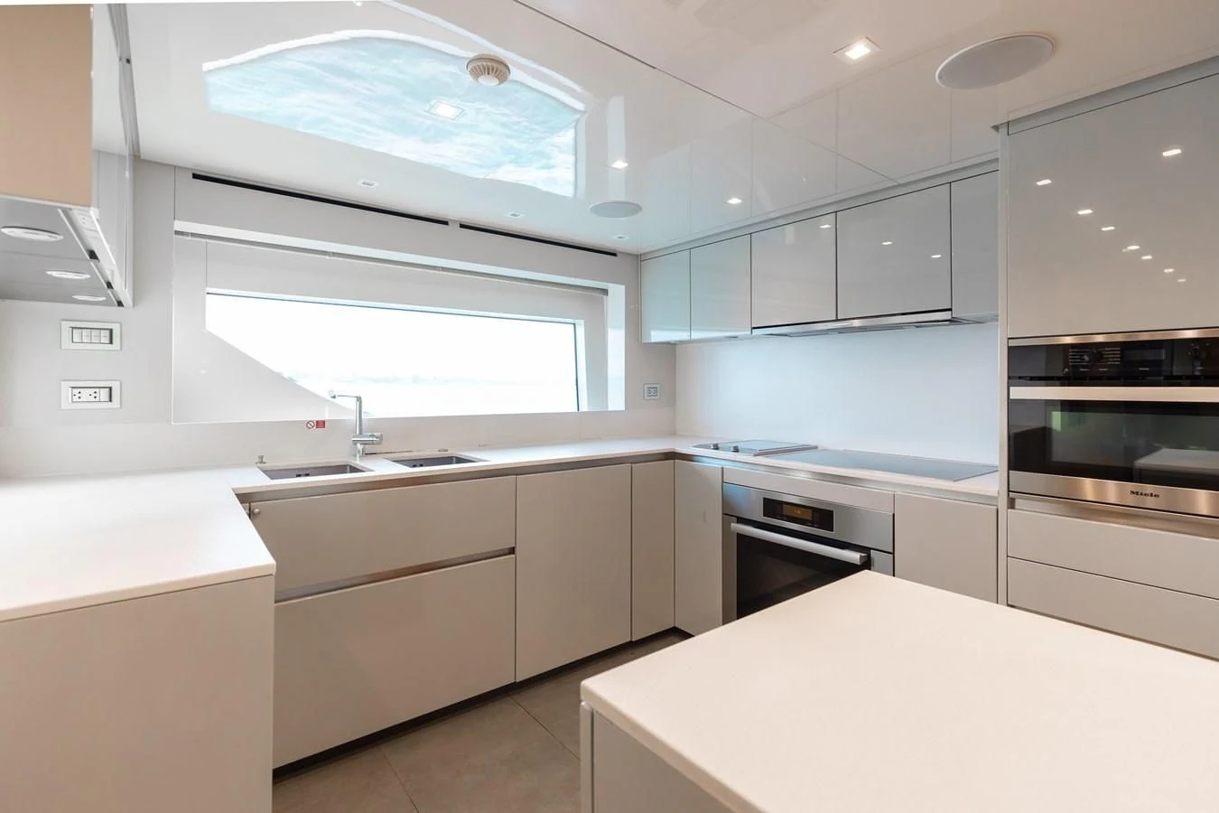 a kitchen with white cabinets aboard TAKARA ONE Yacht for Charter