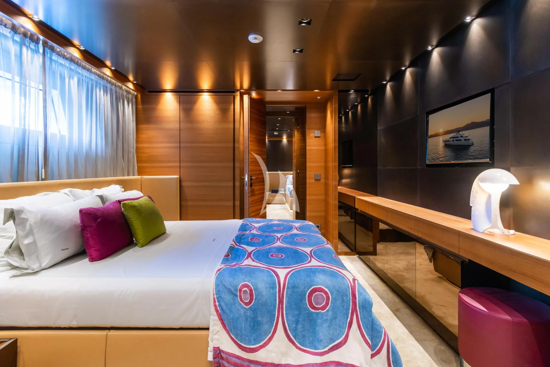 a bed with a purple blanket aboard TAKARA ONE Yacht for Charter