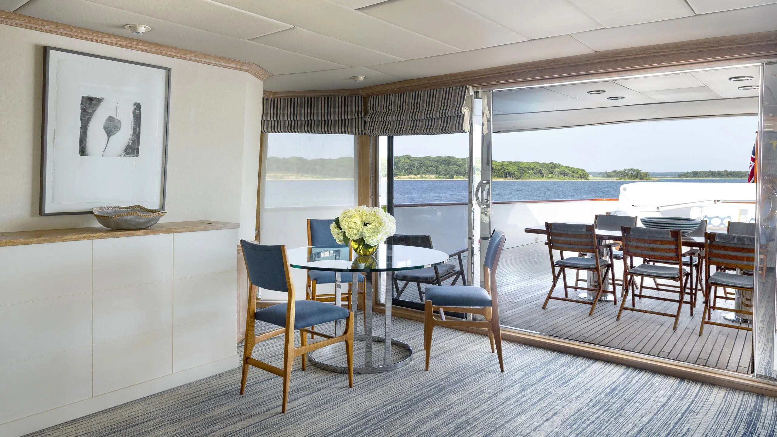 a room with a table chairs and a window aboard NATALIA V Yacht for Sale