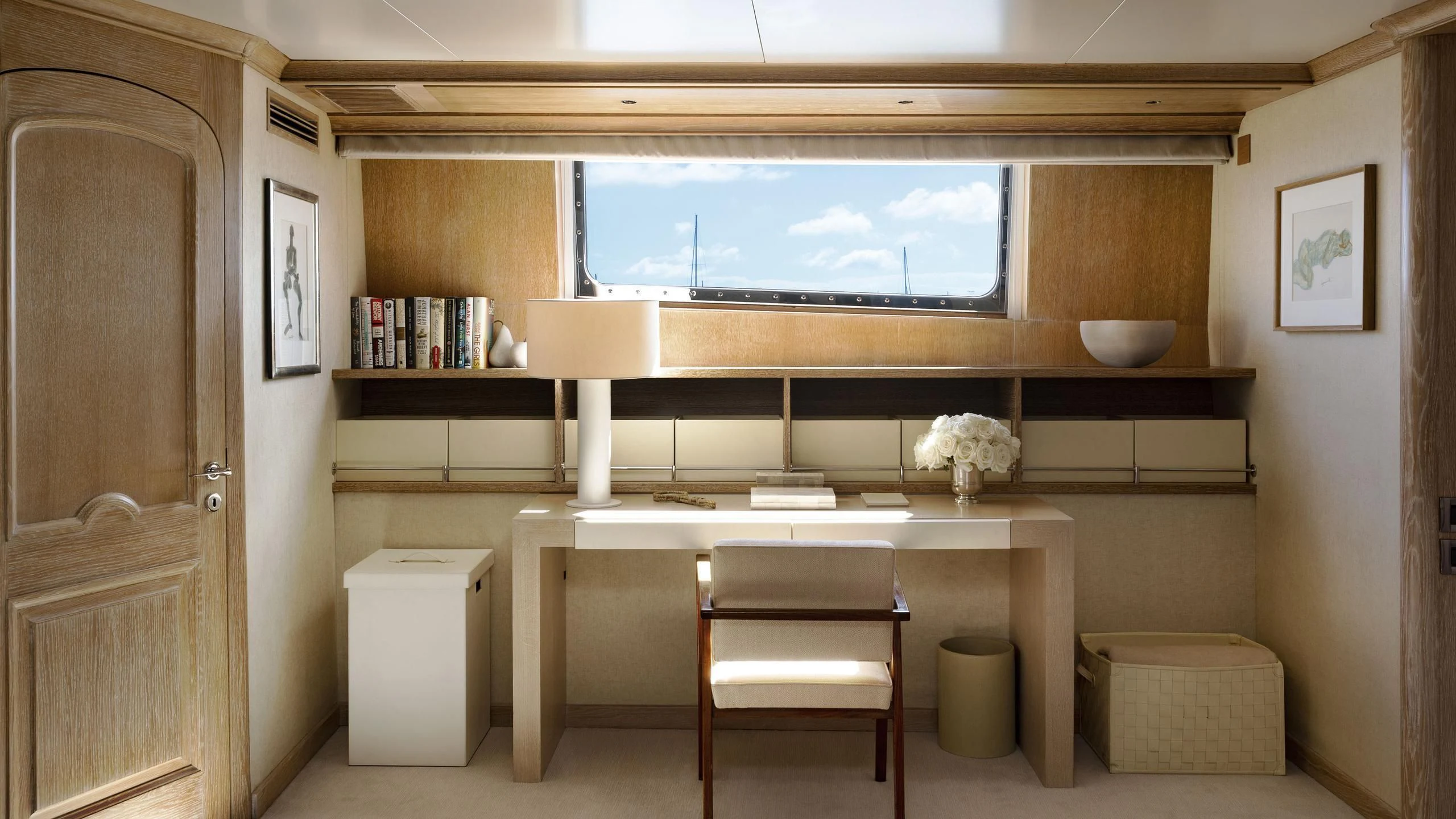 a room with a tv and a shelf with books aboard NATALIA V Yacht for Sale