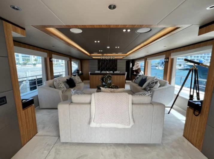 a living room with a large window aboard CAROBELLE Yacht for Sale