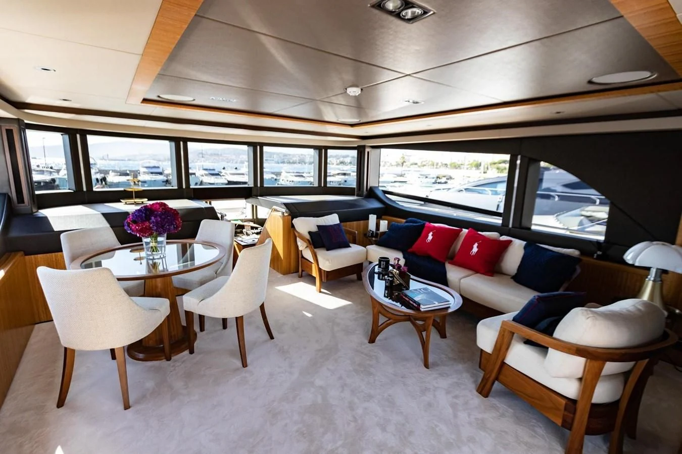 a room with a table chairs and a large window aboard CAROBELLE Yacht for Sale