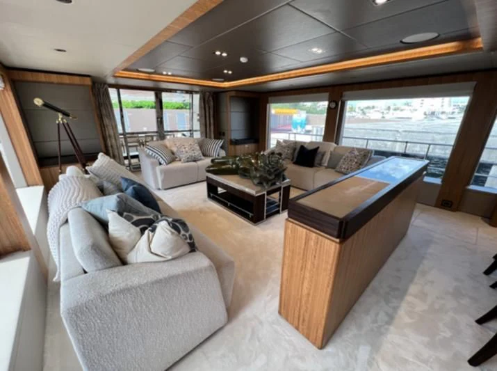 a living room with a large window aboard CAROBELLE Yacht for Sale