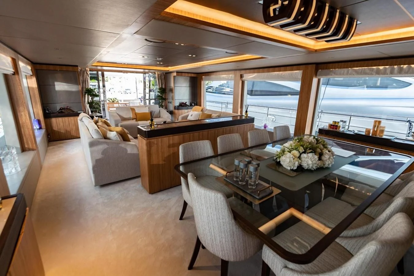 a large room with a table and chairs aboard CAROBELLE Yacht for Sale