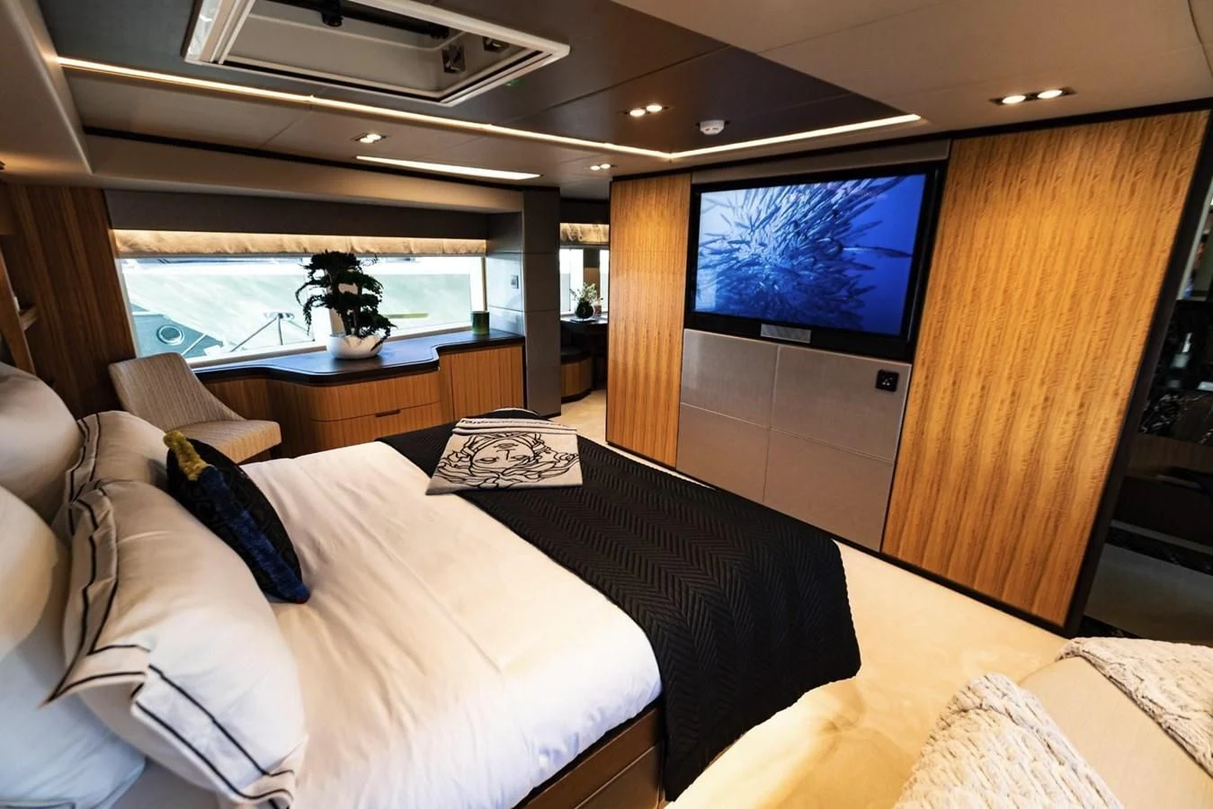 a room with a bed and a tv aboard CAROBELLE Yacht for Sale