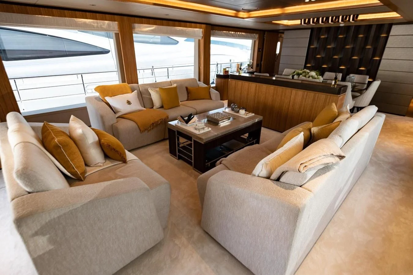 a living room with couches and a coffee table aboard CAROBELLE Yacht for Sale