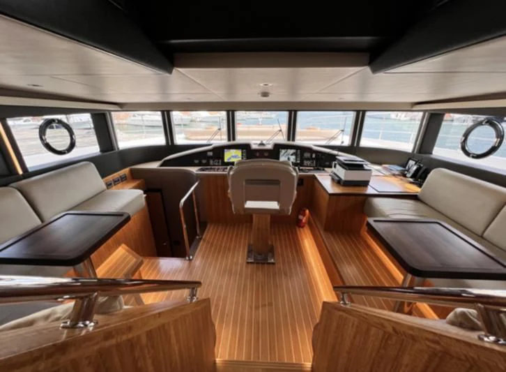 inside of a vehicle with desks and chairs aboard CAROBELLE Yacht for Sale