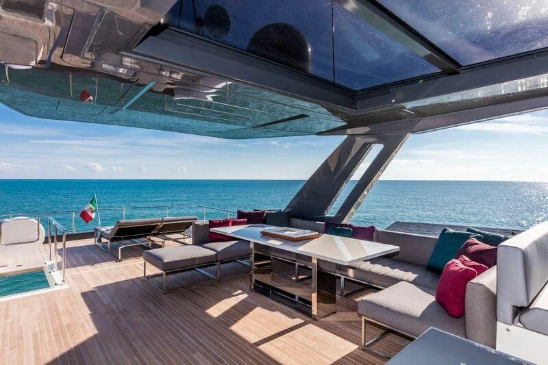 a deck with a pool and a deck with a table and chairs aboard EUPHORIA Yacht for Sale