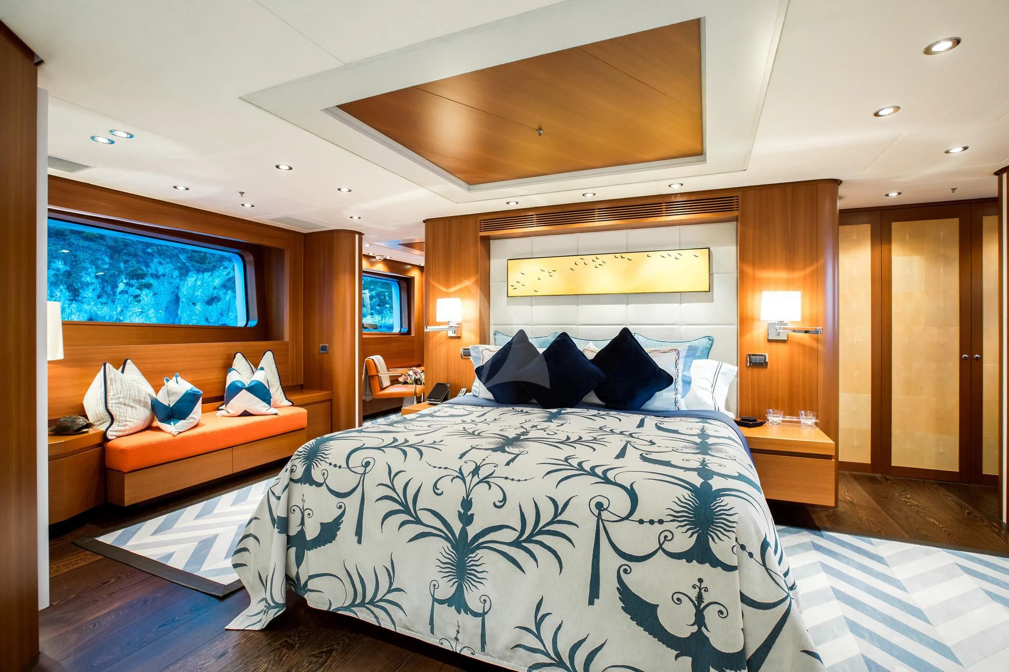 a bedroom with a bed and a desk aboard SARON Yacht for Sale