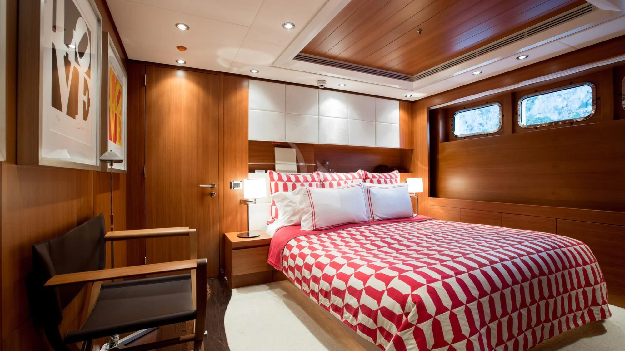 a room with a bed and a piano aboard SARON Yacht for Sale