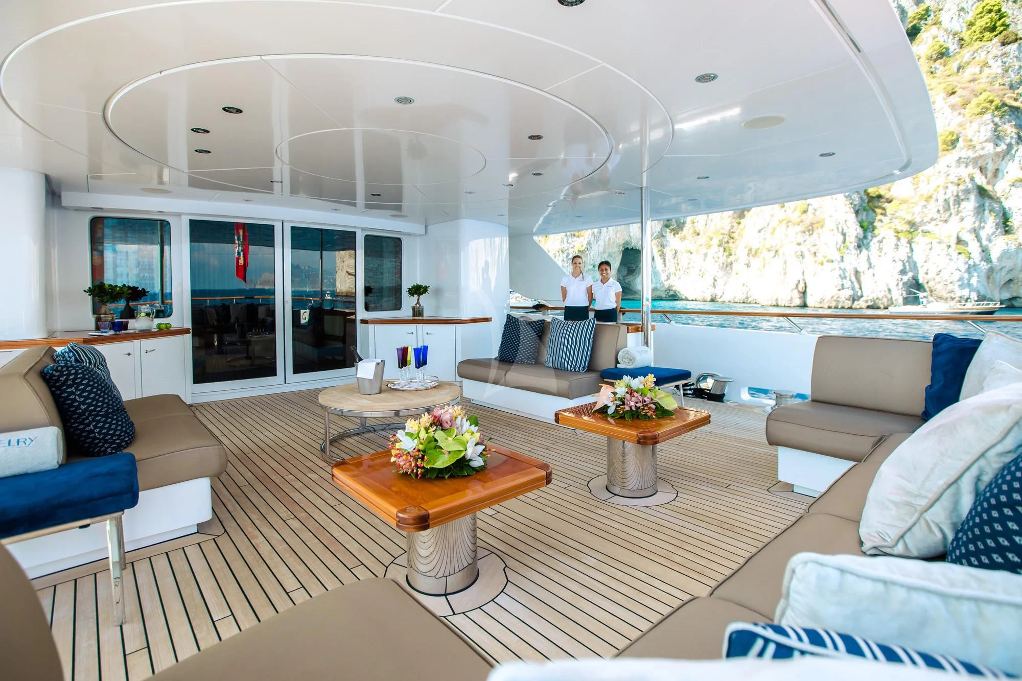 a living room with a table and couches aboard SARON Yacht for Sale