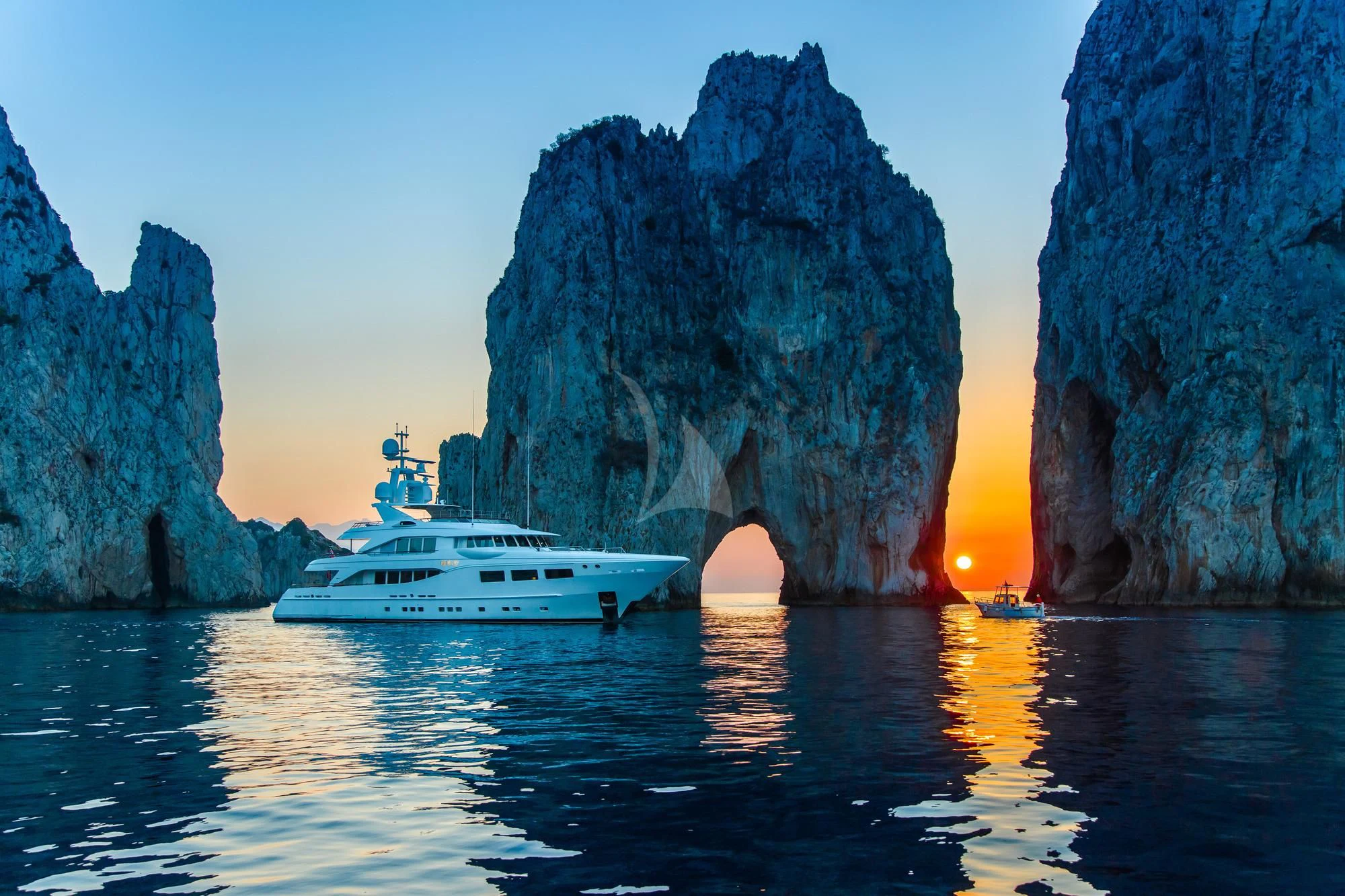 a boat in the water by a cliff aboard SARON Yacht for Sale