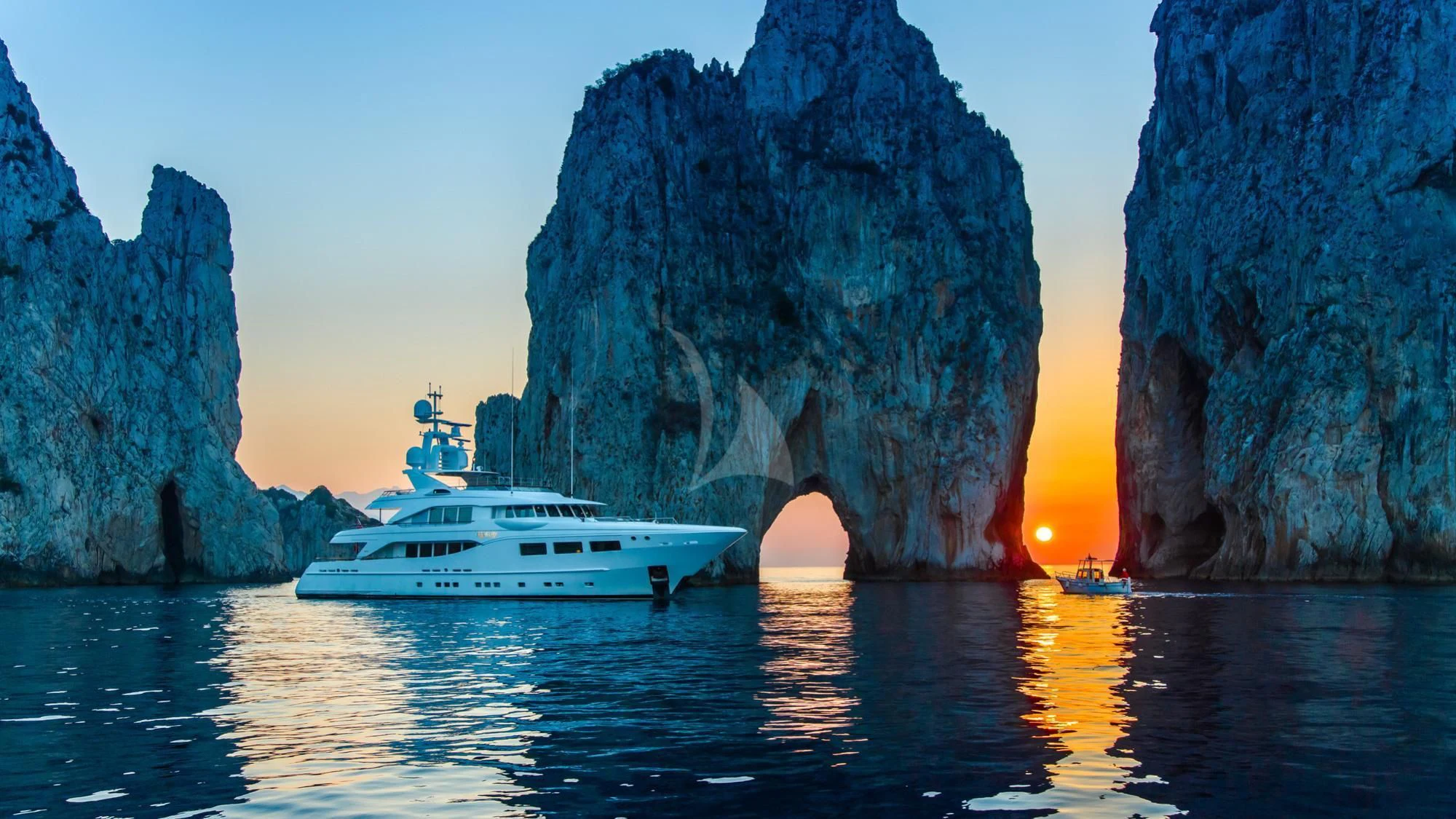 a boat in the water by a cliff aboard SARON Yacht for Sale