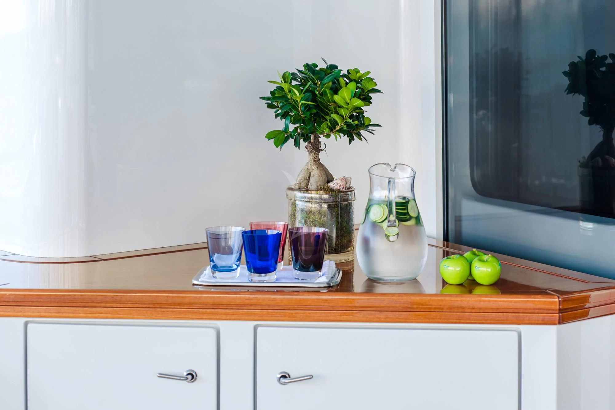 a counter top with glasses and a plant on it aboard SARON Yacht for Sale