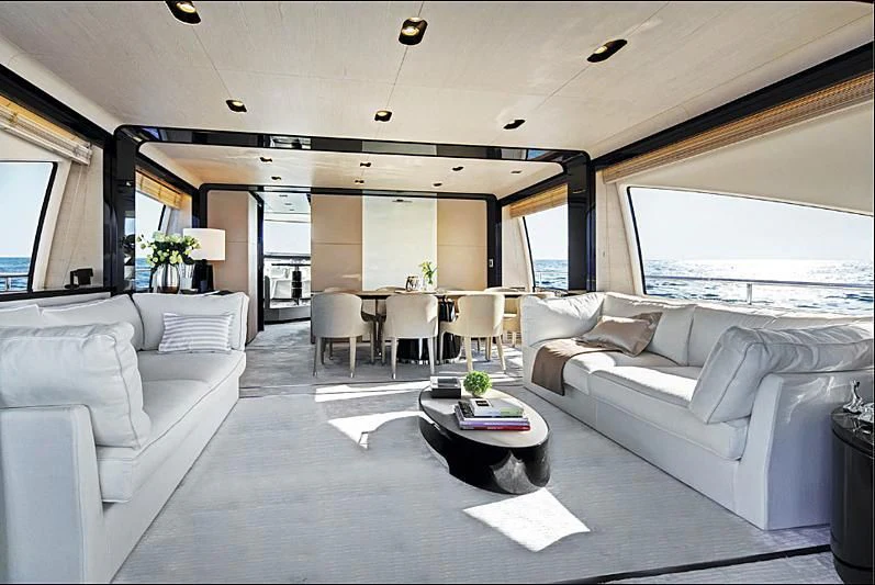 a living room with a couch and a table aboard PARALLAX Yacht for Sale