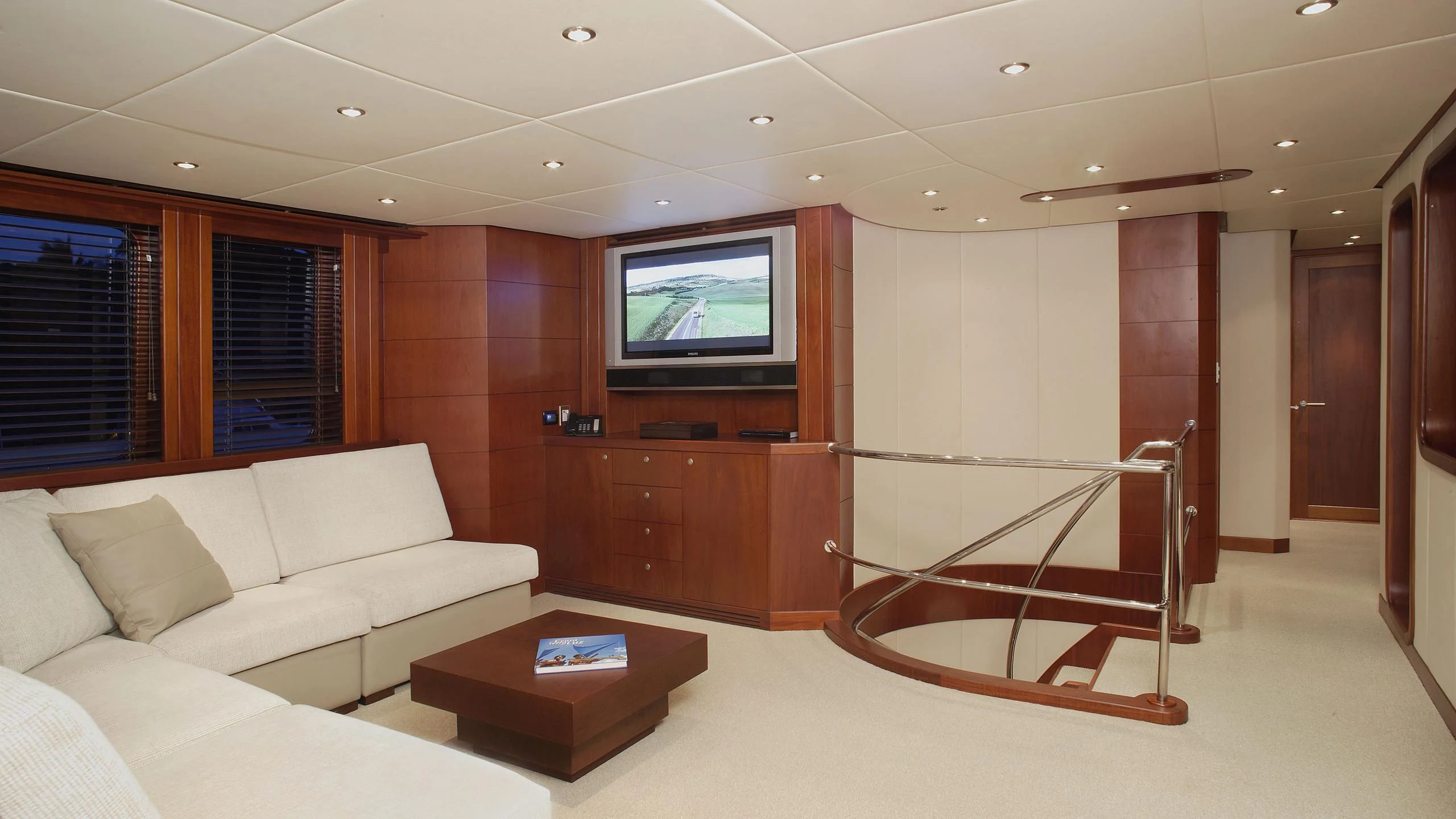 a living room with a large screen aboard IF ONLY Yacht for Sale