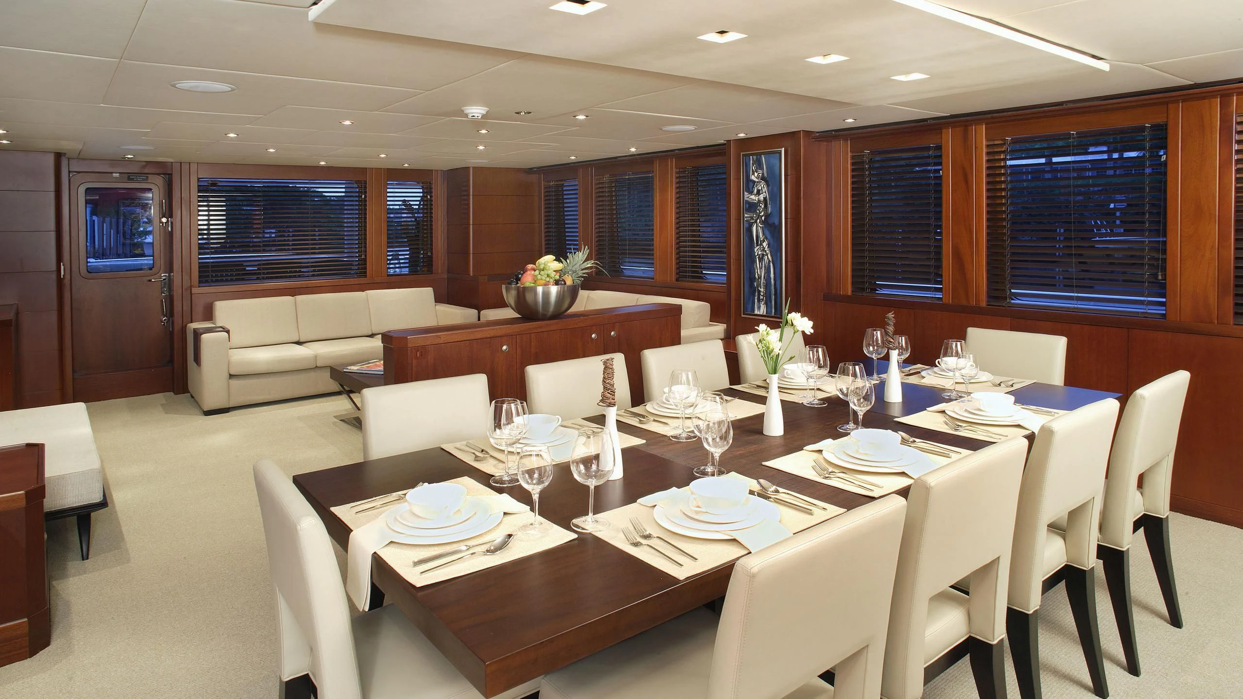 a large room with tables and chairs aboard IF ONLY Yacht for Sale