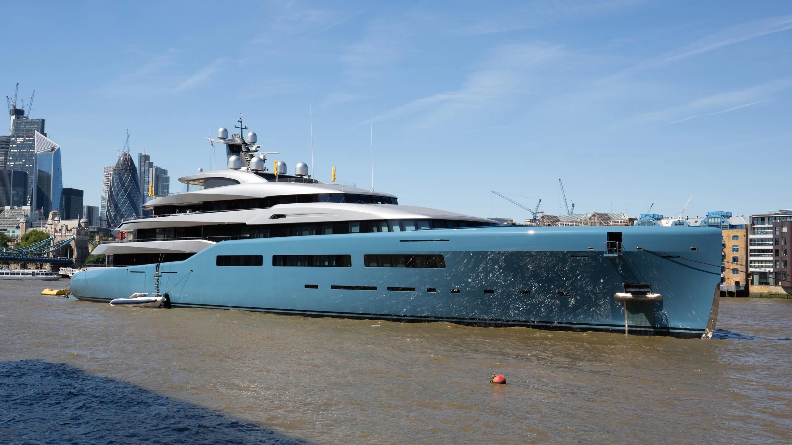 a large white yacht docked at a pier aboard AVIVA Yacht for Sale