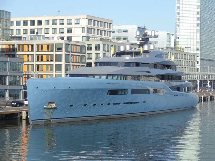 a large white boat in a harbor aboard AVIVA Yacht for Sale