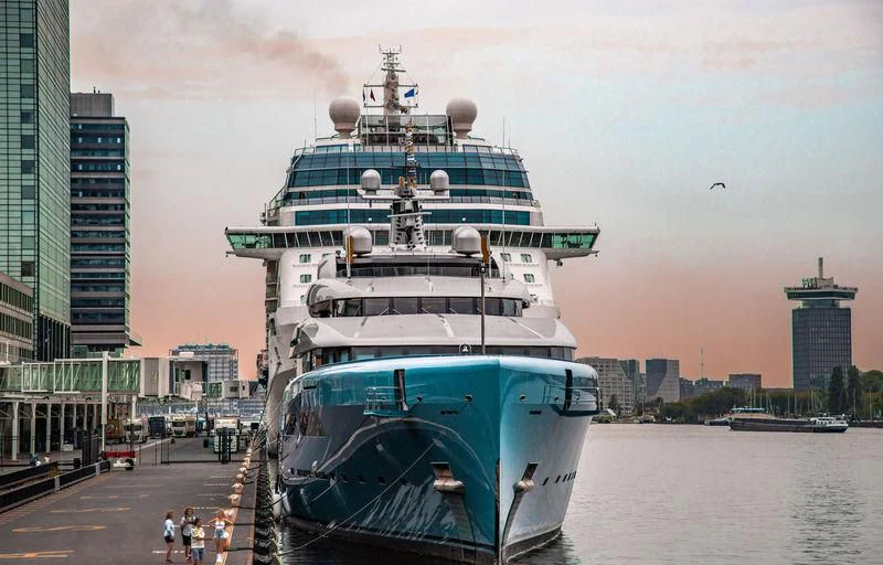 a large ship docked at a port aboard AVIVA Yacht for Sale