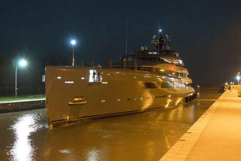 a large military ship on a dock aboard AVIVA Yacht for Sale