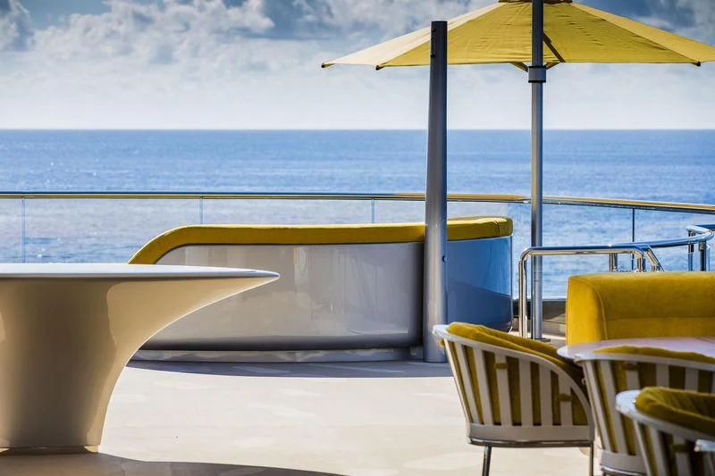 a group of chairs and umbrellas on a beach aboard AVIVA Yacht for Sale