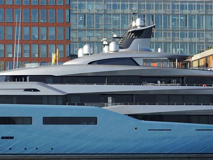 a jet flying over a building aboard AVIVA Yacht for Sale