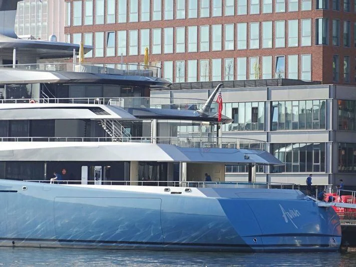 a large boat docked in front of a building aboard AVIVA Yacht for Sale