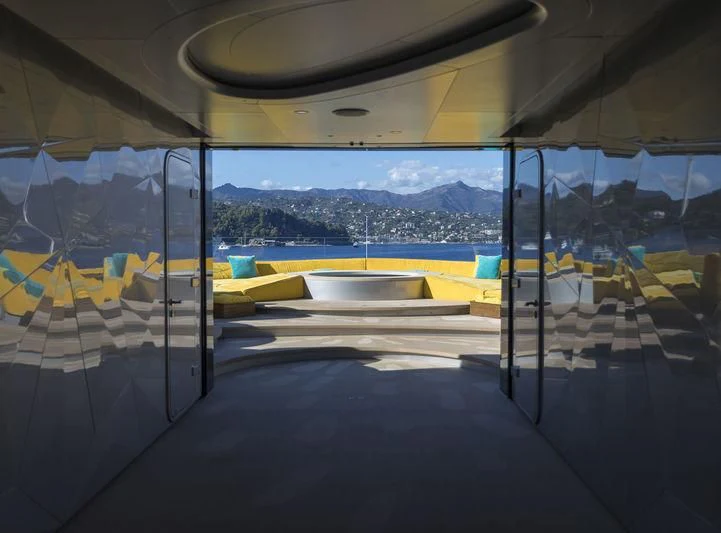 a room with a view of a city and mountains aboard AVIVA Yacht for Sale